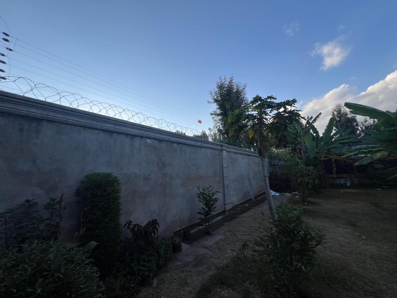 Electric fence wiring along residential perimeter wall